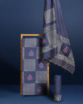 Dark blue Katan silk suit set hand block printed in a checkerboard grid of white and pale pink leaf motifs and vertical stripes, with a botanical border along the dupatta.