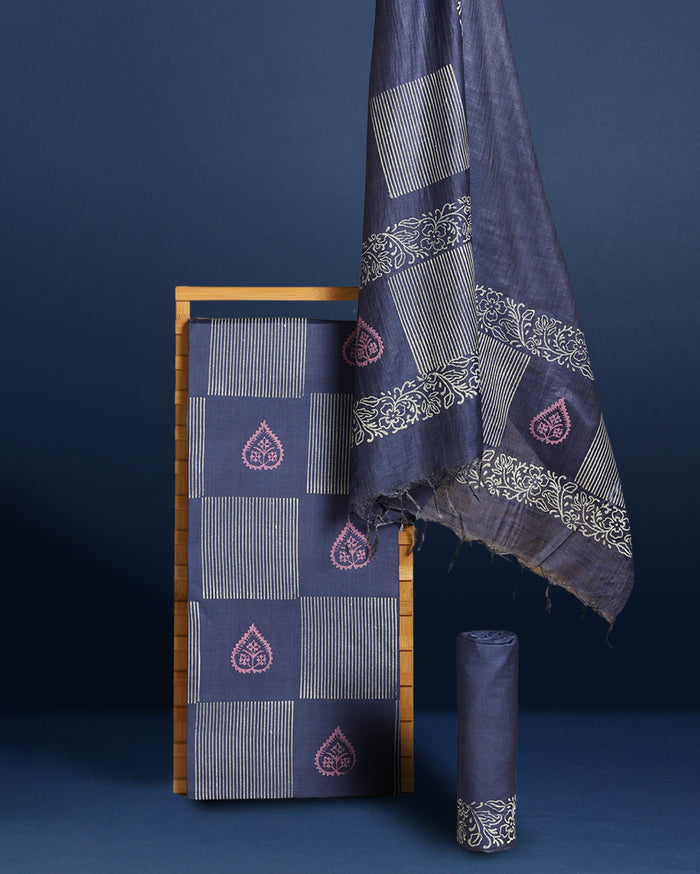 Dark blue Katan silk suit set hand block printed in a checkerboard grid of white and pale pink leaf motifs and vertical stripes, with a botanical border along the dupatta.