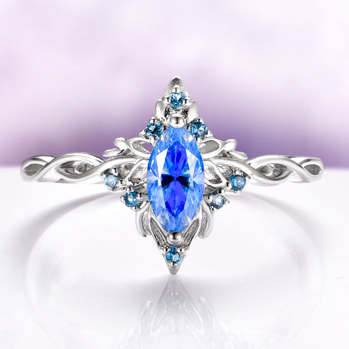 Blue Moissanite Butterfly Marquise Engagement Ring in 14K White Gold by Aquamarise Gold, featuring a nature-inspired band with intricate details and vibrant blue gemstones for a unique engagement ring.
