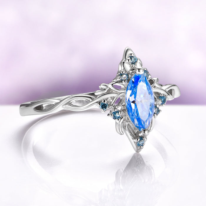 Blue Moissanite Butterfly Marquise Engagement Ring in 14K White Gold by Aquamarise Gold, featuring a delicate band with nature-inspired details and vibrant blue gemstones for a unique fantasy design.
