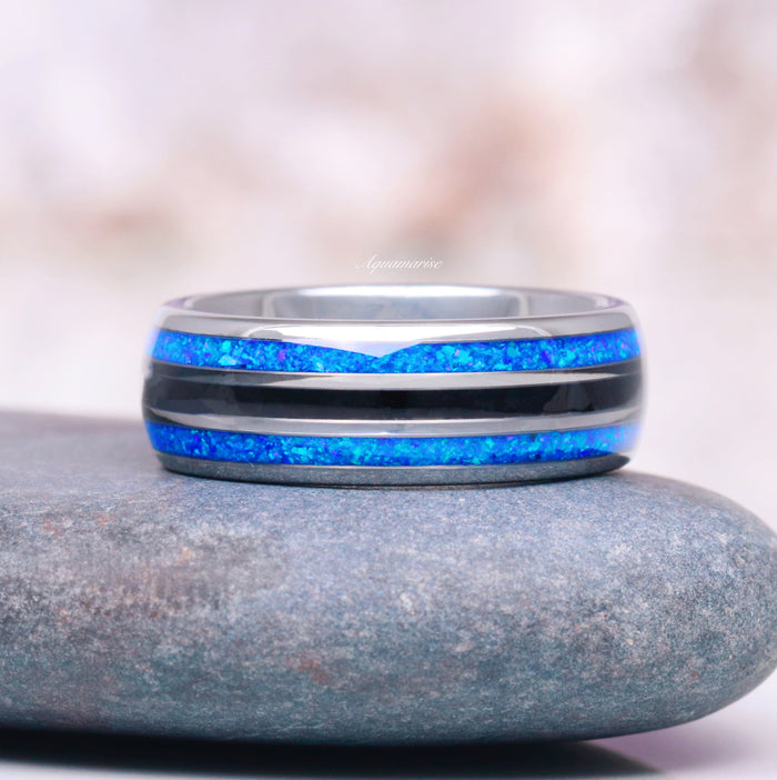 Blue Sapphire & Fire Opal Couples Ring Set featuring vibrant blue fire opal inlays and black onyx accents in a polished band by Aquamarise, a symbol of love and unity.