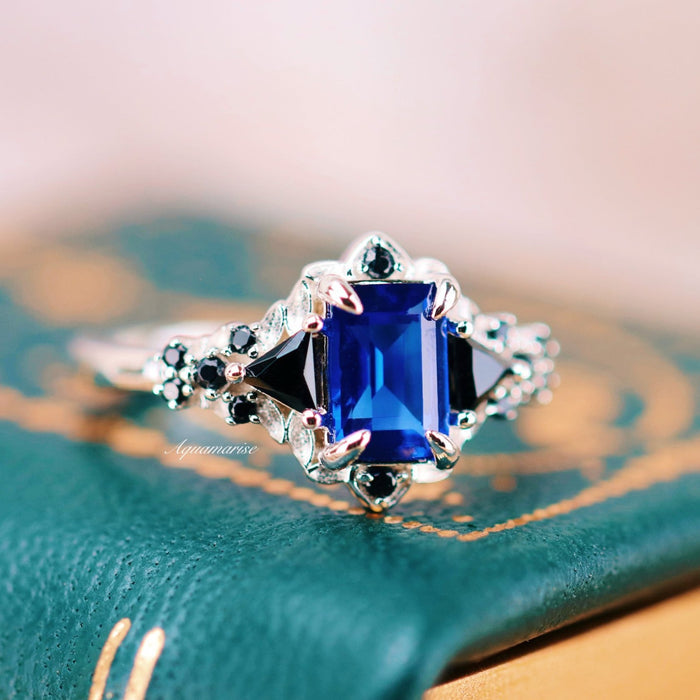 Blue Sapphire & Black Onyx Leaf Engagement Ring- 14K White Gold featuring a deep blue sapphire center with black onyx accents in an intricate white gold setting by Aquamarise Gold.