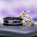 Lab-Grown Diamond & Sapphire Leaf Engagement Ring Set in 14K Solid Yellow Gold (IGI Certified) alongside a black tungsten band with blue sapphire and gold leaf inlay by Aquamarise Gold.