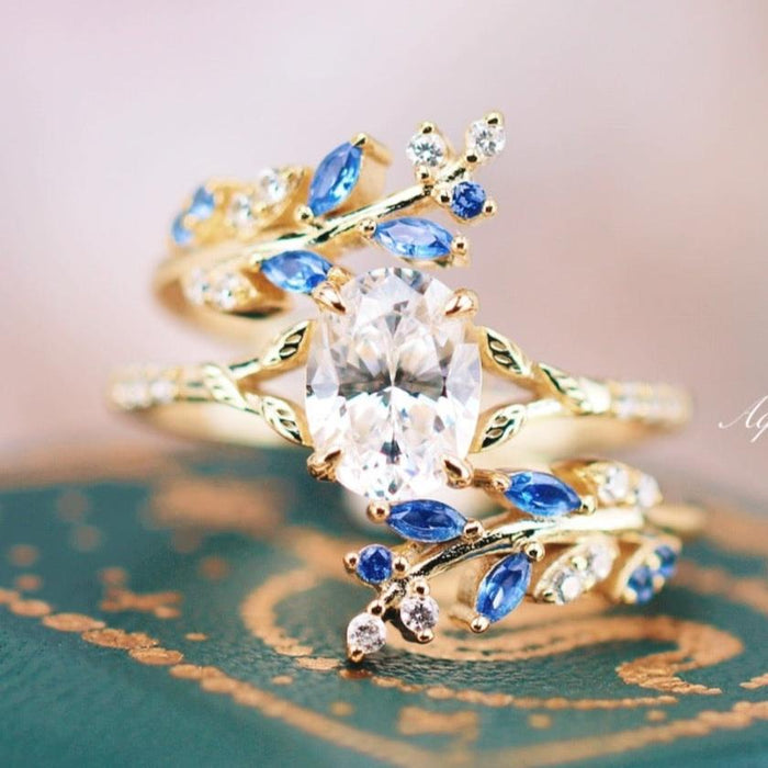Blue Sapphire & Simulated Diamond Leaf Engagement Ring Set in 14K Yellow Gold Vermeil by Aquamarise, featuring intricate leaf motifs with blue sapphires and sparkling simulated diamonds.