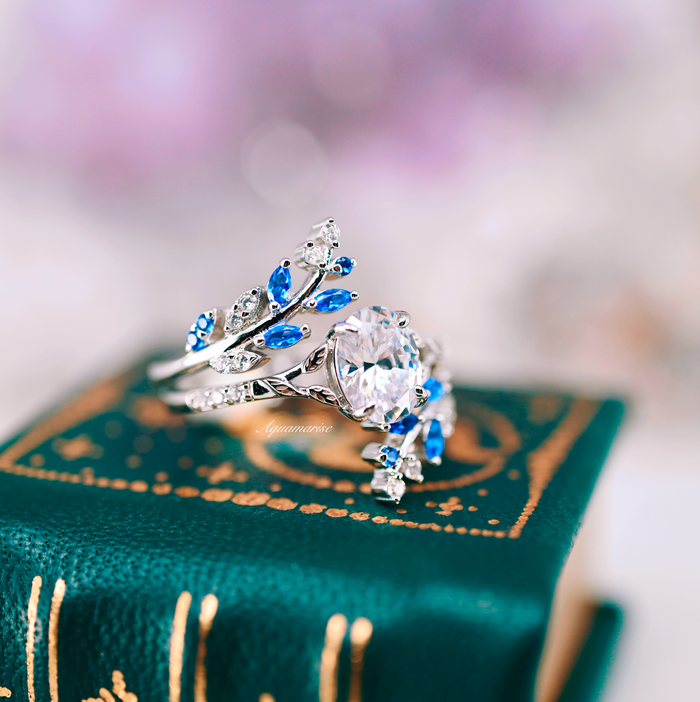 Blue Sapphire & Simulated Diamond Leaf Engagement Ring Set in Sterling Silver by Aquamarise featuring intricate leaf motifs with vibrant blue sapphires and sparkling simulated diamonds.