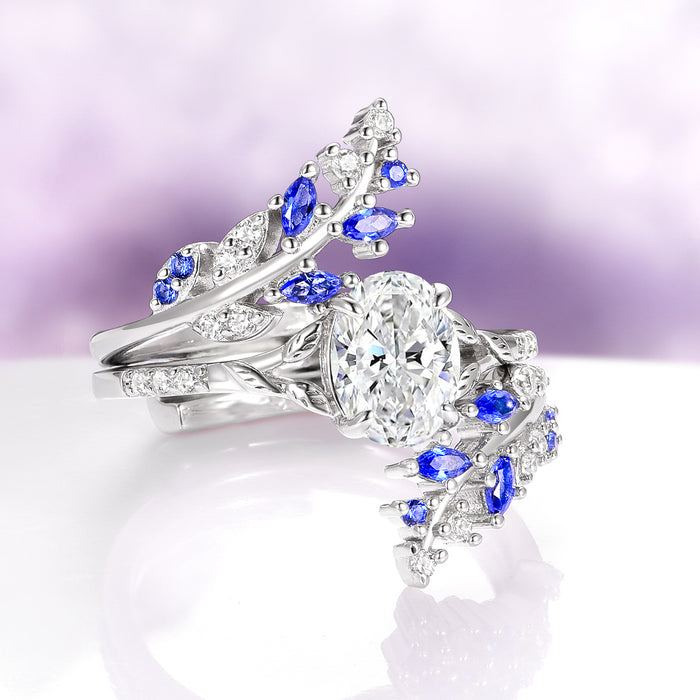 Blue Sapphire & Moissanite Leaf Ring Guard in 14K White Gold by Aquamarise Gold featuring vine-inspired design with marquise-cut blue sapphires and sparkling moissanite accents.