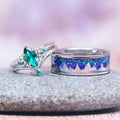 Borealis Forest & Teal Sapphire Couples Ring Set- Northern Lights & Trees featuring a marquise teal sapphire with small accent stones and a matching band with a glowing aurora borealis forest inlay, crafted by Aquamarise from Matching Couples' Rings and September Birthstone Jewelry collections.