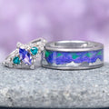 Borealis Tanzanite & Teal Sapphire Couples Ring Set (Mountain Range) by Aquamarise features a marquise-cut tanzanite with teal sapphire accents and a silver band with an iridescent mountain range design, from Matching Couples' Rings and September and December Birthstone Jewelry collections.