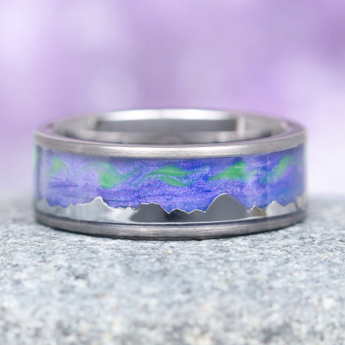 Borealis Tanzanite & Teal Sapphire Couples Ring Set (Mountain Range) by Aquamarise, featuring a polished band with a vibrant purple and green Northern Lights-inspired inlay above a sleek mountain silhouette, part of Matching Couples' Rings and Fantasy-Inspired Couples Rings collections.