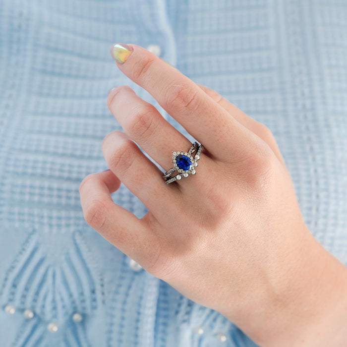 Briar Blue Sapphire and Pearl Engagement Ring Set in Black Ruthenium by Aquamarise features a pear-shaped blue sapphire center surrounded by pearls on intricately designed black ruthenium bands, part of June and September Birthstone Jewelry collections.