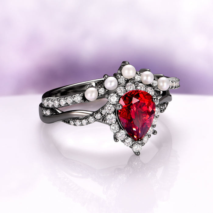 Briar Natural Red Garnet & Pearl Ring Set in Black Ruthenium featuring a pear-shaped garnet, freshwater pearls, and sparkling diamonds in a twisted black ruthenium band by Aquamarise.