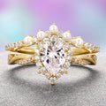 Gold ring with heart-shaped diamond and pearls on a gradient background