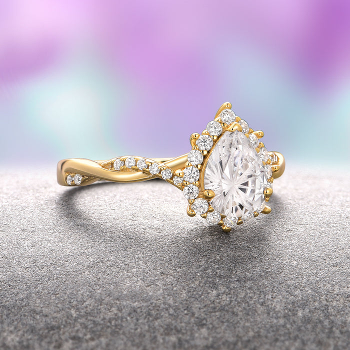 Briar Moissanite Engagement Ring- 14K Solid Yellow Gold (Fantasy Cut) by Aquamarise Gold, featuring a pear-shaped fantasy-cut moissanite surrounded by a halo of small diamonds set on a twisting yellow gold band, from Solid Gold Engagement Rings and Nature-Inspired Engagement Rings collections.
