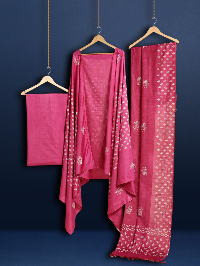 Bright magenta purple katan silk unstitched suit set with off-white floral and geometric hand block print, one plain magenta piece, and a fringed geometric border.