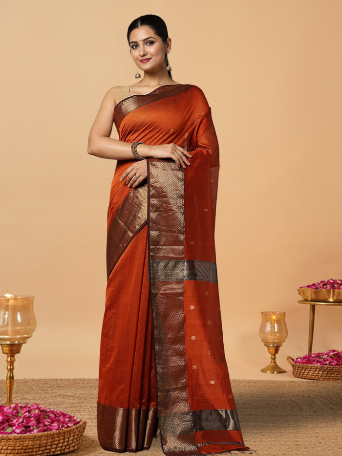 Handloom Maheshwari silk saree in burnt orange, flower buti scattered across the body, with a wide golden zari border