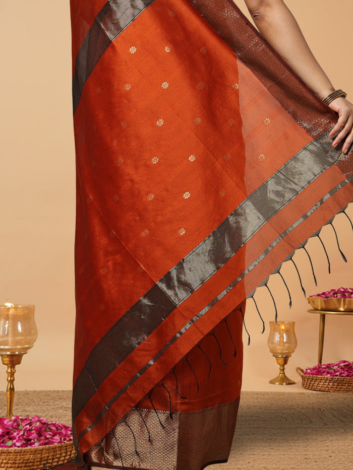 Handloom Maheshwari silk saree in burnt orange, flower buti scattered across the body, with a wide golden zari border