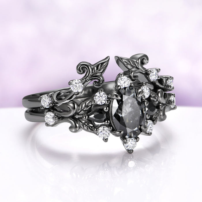 Angled view of the Carmilla gray moissanite ring and enhancer band worn together, showing how the open wrap closes around the center stone