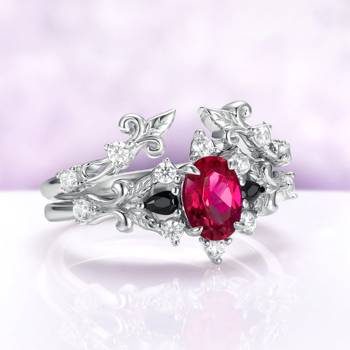 Angled view of the Carmilla ruby bridal set showing the black onyx pears, cubic zirconia accents and carved scrollwork