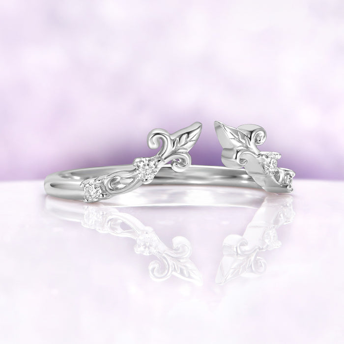 Angled view of the Carmilla ruby set enhancer band showing the open front and carved leaf terminals