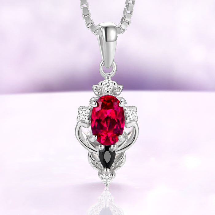 Carmilla lab-grown ruby pendant necklace in sterling silver, oval center with a black onyx pear on a box chain