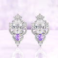 Carmilla moissanite stud earrings in sterling silver, oval centers with natural amethyst pears and carved leaf and scroll frames