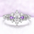 Carmilla engagement ring in sterling silver, oval moissanite between natural amethyst pears with carved leaf and vine shoulders