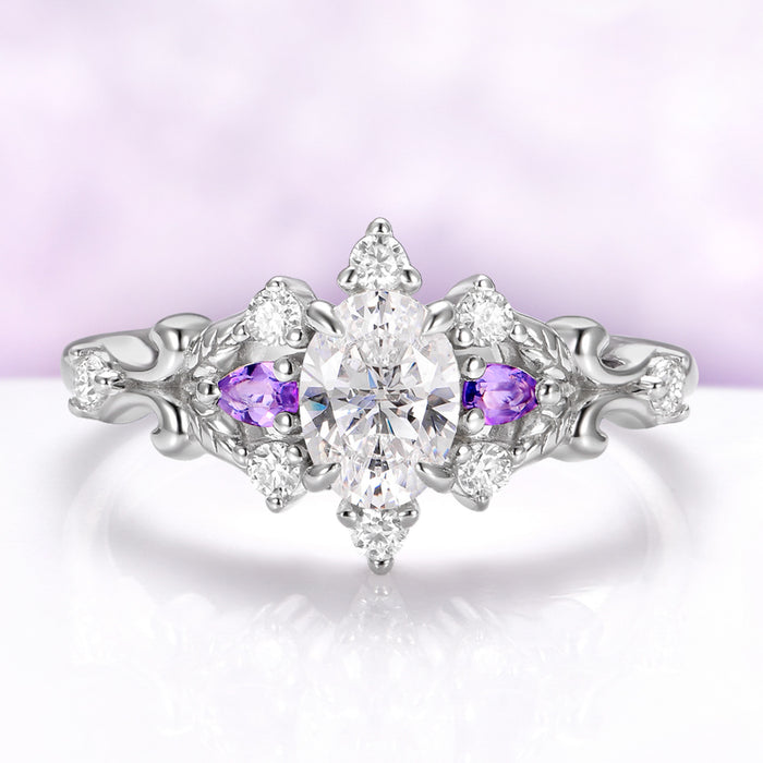 Carmilla engagement ring in sterling silver, oval moissanite between natural amethyst pears with carved leaf and vine shoulders