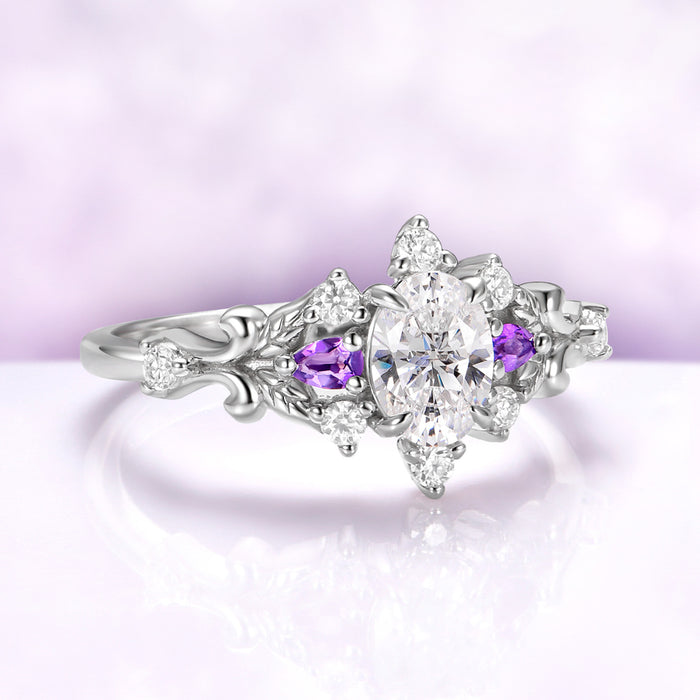 Angled view of the Carmilla amethyst engagement ring showing the leaf carving, scrollwork shoulders and moissanite accents