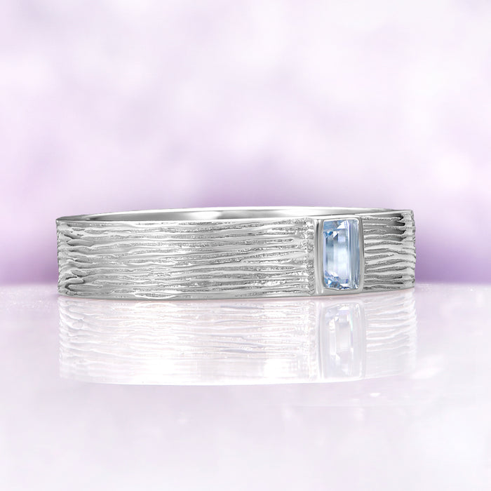 Celtic Aquamarine Couples Ring Set by Aquamarise featuring a textured sterling silver band with a rectangular aquamarine gemstone, part of Matching Couples' Rings and March Birthstone Jewelry collections.