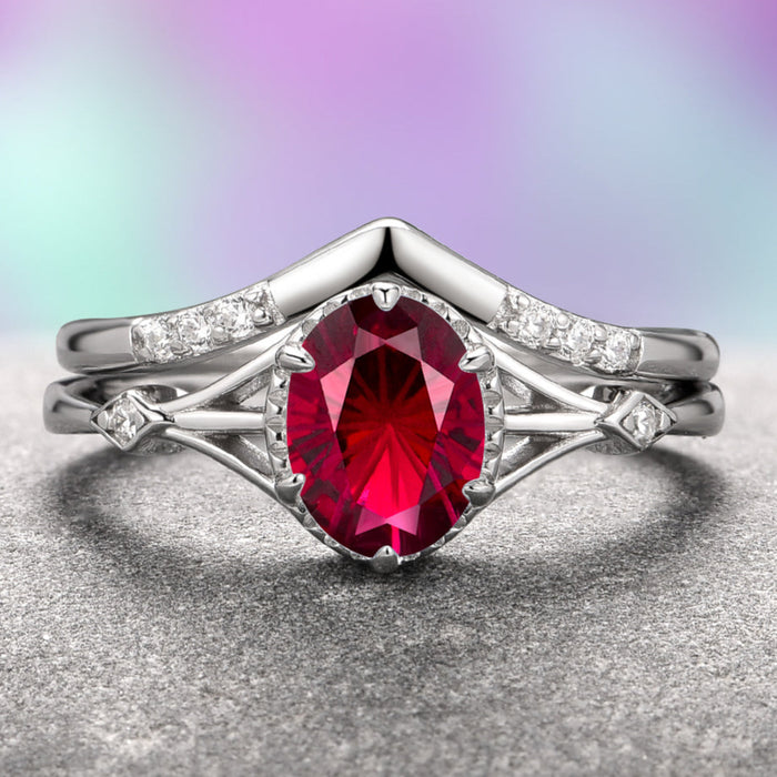 A two-piece Celtic ring set with a star-cut ruby center stone and accent stones, crafted in 14K white gold, displayed against a purple and gray background.