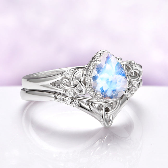 Celtic Knot Moonstone Engagement Ring Set in 14K White Gold by Aquamarise Gold, featuring a pear-shaped moonstone with intricate Celtic knot details and sparkling diamond accents.
