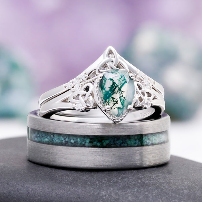 The Celtic knot moss agate ring set resting on the men's off-set moss agate tungsten wedding band
