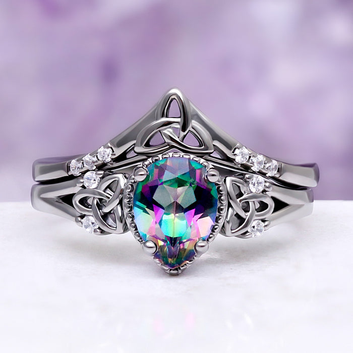 Celtic Knot Mystic Topaz Ring Set in Black by Aquamarise, with a pear-cut mystic topaz and Celtic knot detailing on a black band.