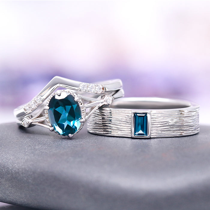 Celtic Natural London Blue Topaz Couples Ring Set by Aquamarise featuring a sterling silver band with textured design and rectangular blue topaz, paired with an intricately detailed ring showcasing a large oval London blue topaz and sparkling diamond accents, part of Matching Couples' Rings and November Birthstone collections.