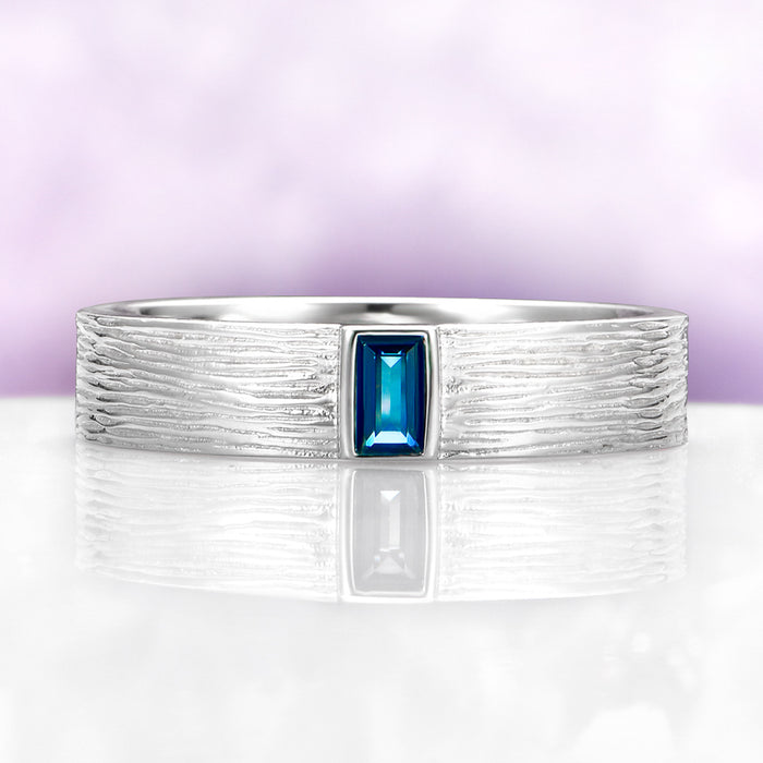 Celtic Natural London Blue Topaz Couples Ring Set by Aquamarise, featuring a textured sterling silver band with a rectangular London Blue Topaz center stone in a nature-inspired design.