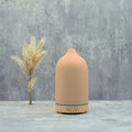 color-changing ceramic essential oil diffuser showcasing a sleek design with LED function against a minimalist backdrop.