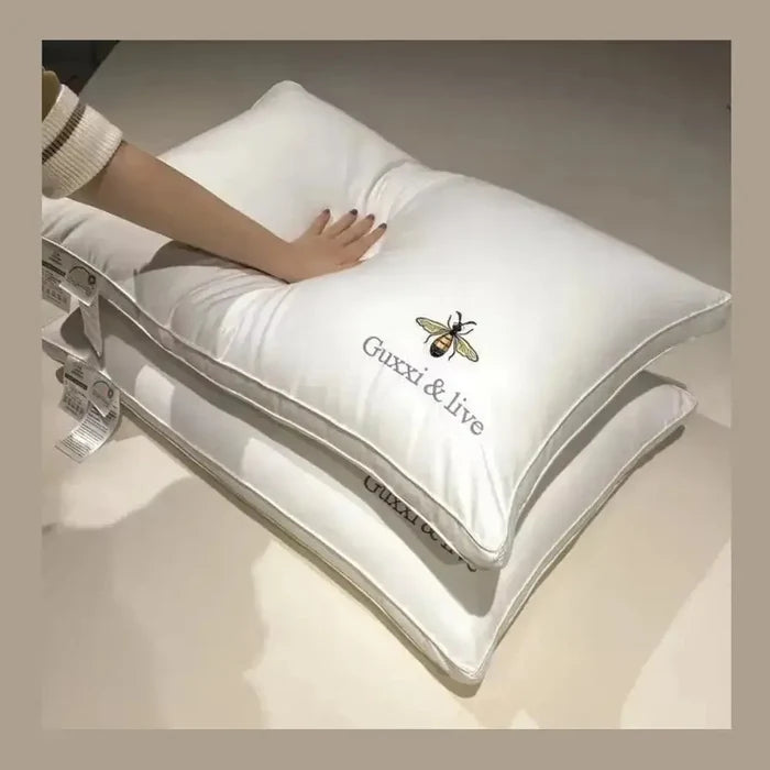 Cervical massage pillow shown with a hand pressing it, featuring a stylish design by Guxxi & Live.