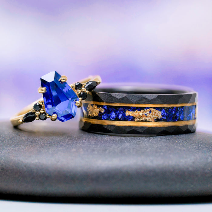 Coffin Cut Blue Sapphire and Gold Leaf Couples Ring Set featuring a faceted black band with blue sapphire and gold leaf inlay and a gold ring with geometric blue sapphire by Aquamarise.