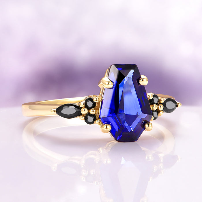 Coffin Cut Blue Sapphire and Gold Leaf Couples Ring Set featuring a striking deep blue coffin-cut sapphire with black gemstone accents in gold, crafted by Aquamarise.
