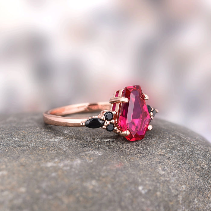 Close-up of Coffin Cut Ruby and Rose Gold Leaf Couples Ring Set featuring a vibrant red ruby, black diamonds, and rose gold band by Aquamarise, symbolizing strength and elegance.