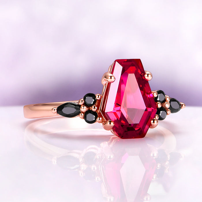 Coffin Cut Ruby and Rose Gold Leaf Couples Ring Set by Aquamarise, featuring a bold coffin-cut ruby centerpiece with black onyx accents on a polished rose gold band for matching couples rings.