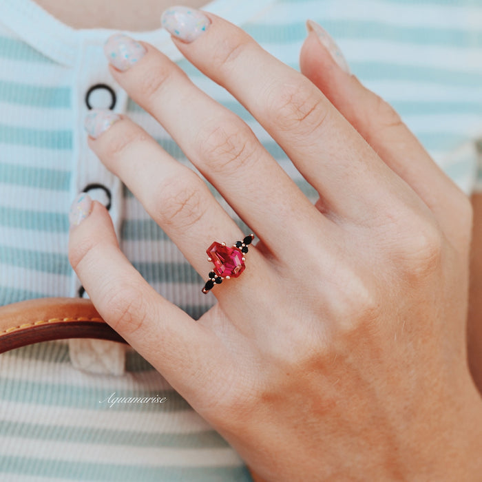 Coffin Cut Ruby and Rose Gold Leaf Couples Ring Set displayed on hand, featuring a striking red ruby and black diamond accents in a rose gold setting by Aquamarise.