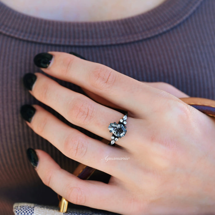 Black ruthenium Herkimer diamond coffin cut engagement ring worn on a hand with black nail polish