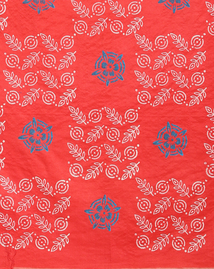 Coral red Katan silk suit set hand block printed with blue circular motifs and small white leaf sprigs with metallic gold detail, and a frayed fringe on the dupatta.