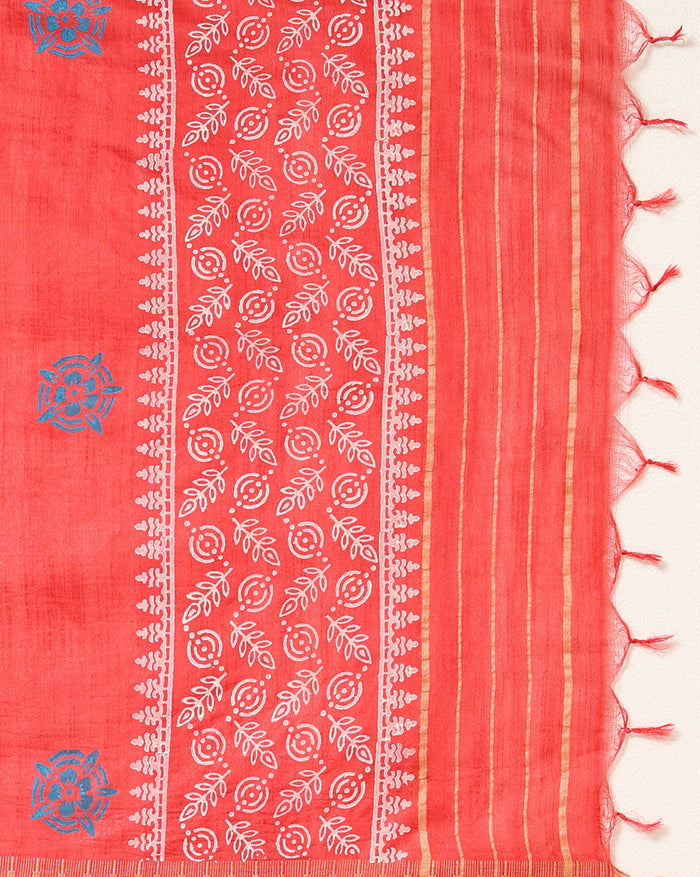 Coral red Katan silk suit set hand block printed with blue circular motifs and small white leaf sprigs with metallic gold detail, and a frayed fringe on the dupatta.
