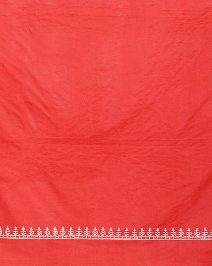 Coral red Katan silk suit set hand block printed with blue circular motifs and small white leaf sprigs with metallic gold detail, and a frayed fringe on the dupatta.