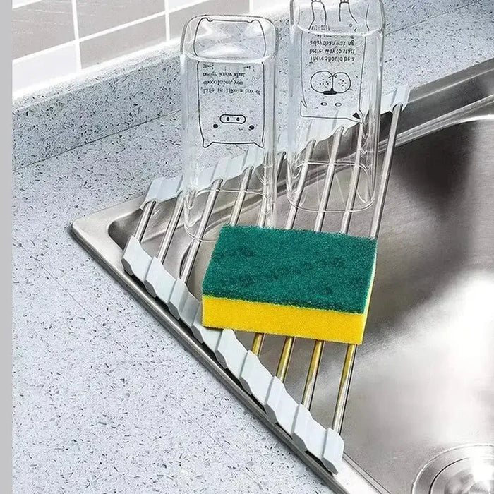 corner sink dish drying rack with raised surface for drying glasses and sponge in modern kitchen sink.