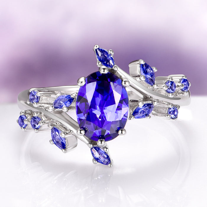 Orion Nebula™ & Cornflower Sapphire Leaf Couples Ring Set from Aquamarise featuring a silver band with vivid cornflower sapphire gemstones in a delicate leaf design for matching couples rings.
