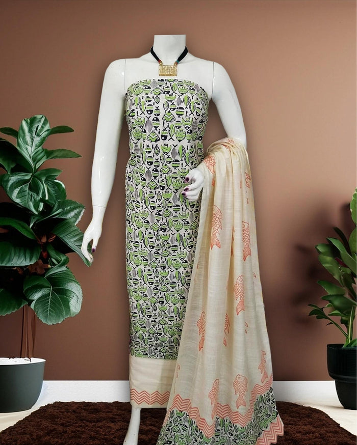 Cream and white Katan silk unstitched suit set hand block printed with a small all-over fish motif in green, black and peach, sparse fish motifs on the dupatta and a zigzag border at the hem.