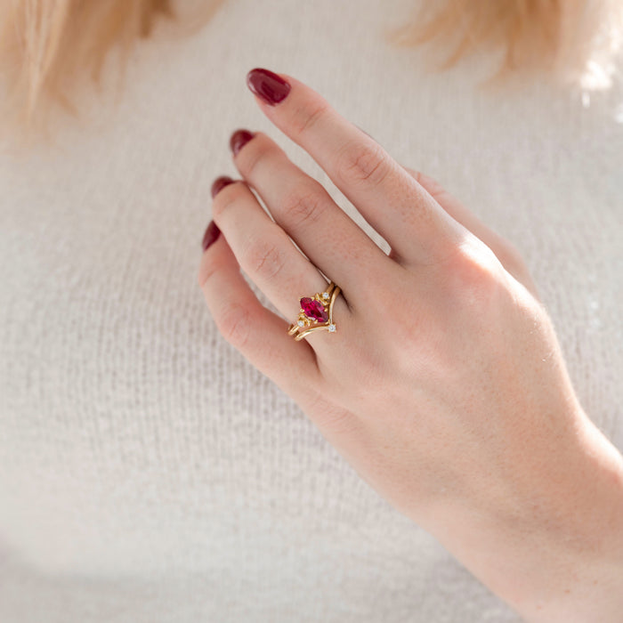 Crescent Moon Ruby Engagement Ring Set in 14K Solid Yellow Gold featuring a marquise-cut ruby center stone with crescent moon and diamond accents, styled on a hand with matching gold bands, crafted by Aquamarise Gold.